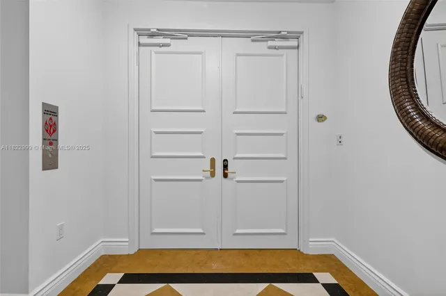 a bathroom with a granite countertop sink mirror vanity and toilet