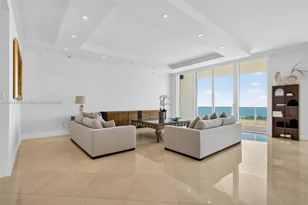 a view of a livingroom with furniture and floor to ceiling window