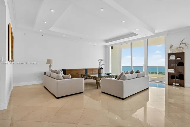 a view of a livingroom with furniture and floor to ceiling window