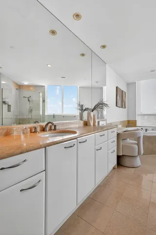 a dining room with furniture a chandelier and outdoor view