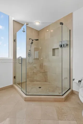 a dining room with furniture a chandelier and wooden floor