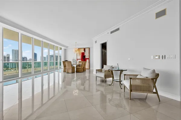 a kitchen with stainless steel appliances kitchen island granite countertop a refrigerator a stove a sink a dining table and chairs with wooden floor