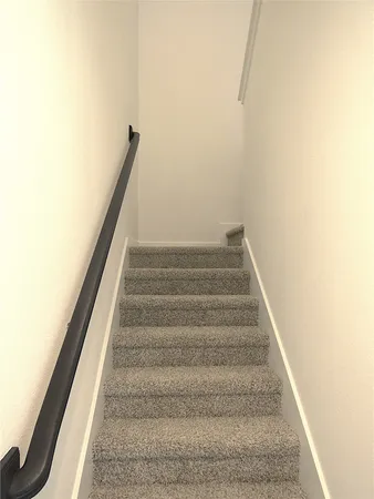 a view of staircase with white walls