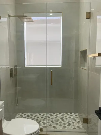 a bathroom with a toilet and a shower