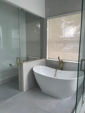 a bathroom with a bathtub and a shower