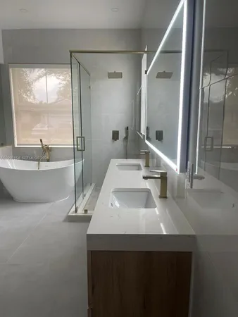 a bathroom with a sink and a large mirror