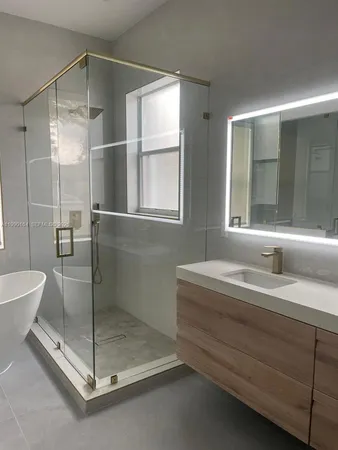a bathroom with a granite countertop sink mirror and toilet