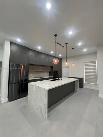 a large kitchen with counter space and a sink
