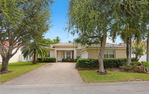 a front view of house with yard and green space
