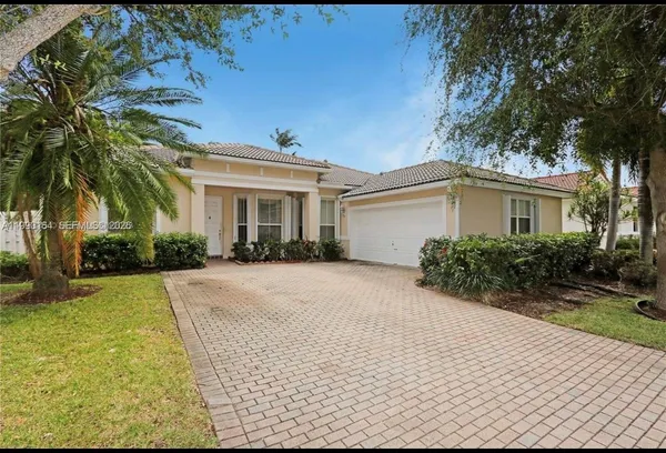 a front view of house with yard and green space