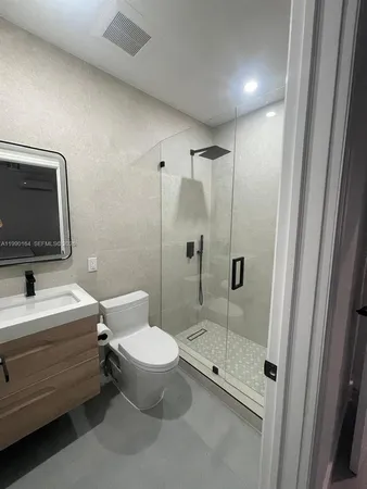a bathroom with a toilet a sink and shower