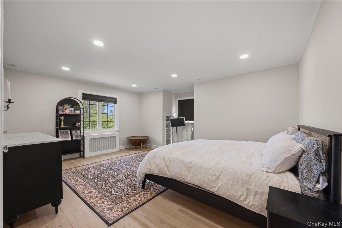 311 Lyncroft Road New Rochelle, NY 10804 - Photo 21 of 39 a large bedroom with a bed and a table in it
