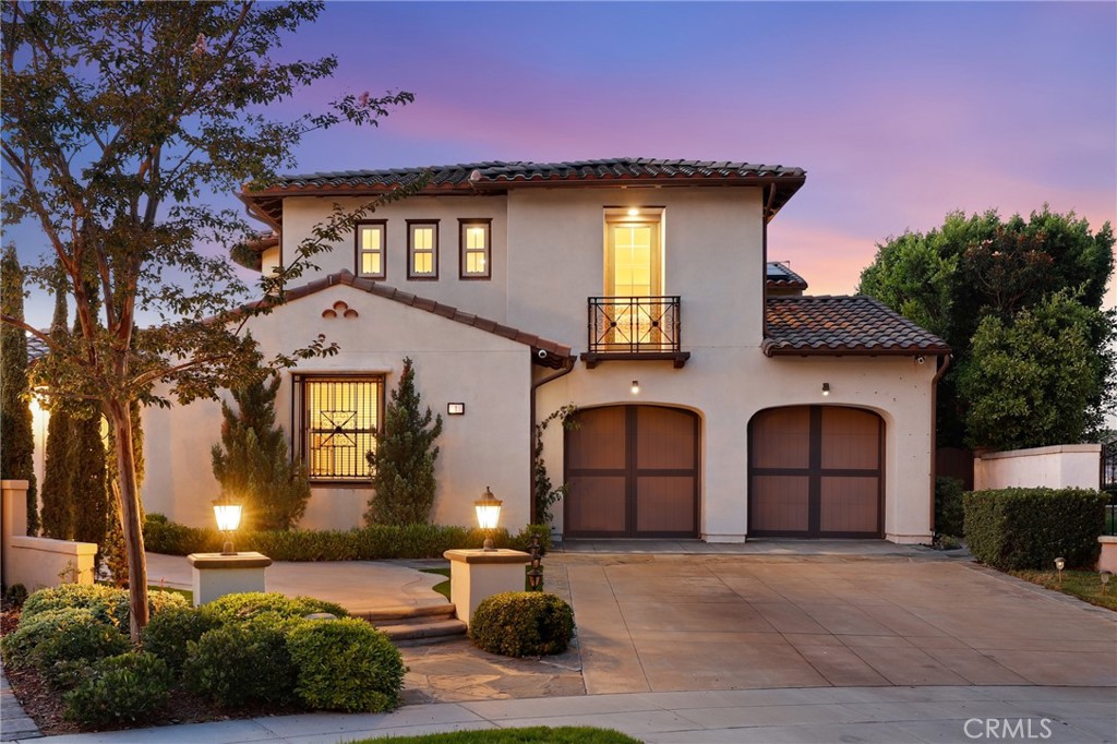 a front view of a house with yard and parking