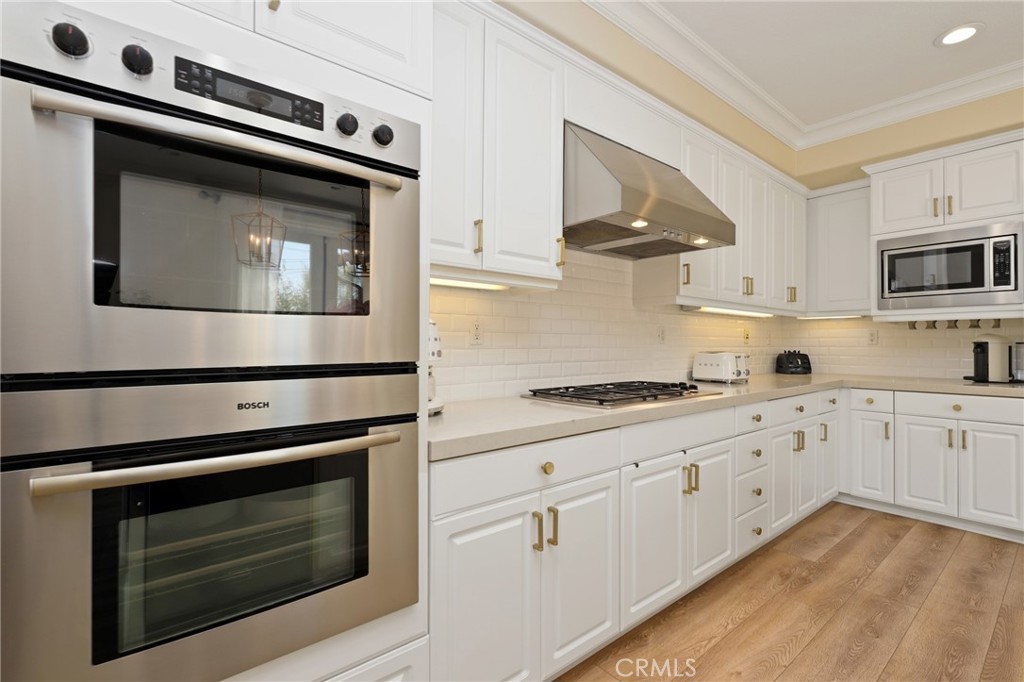 1 David Street Ladera Ranch, CA 92694 - Photo 13 of 66 a kitchen with stainless steel appliances white cabinets and a stove top oven