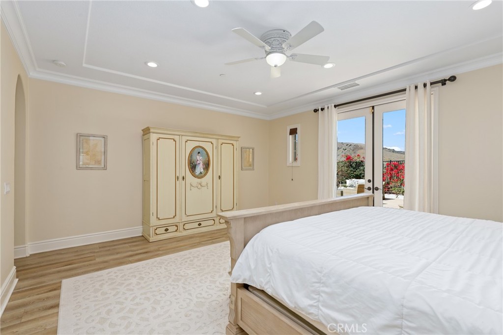 1 David Street Ladera Ranch, CA 92694 - Photo 19 of 66 a spacious bedroom with a large bed and a chandelier