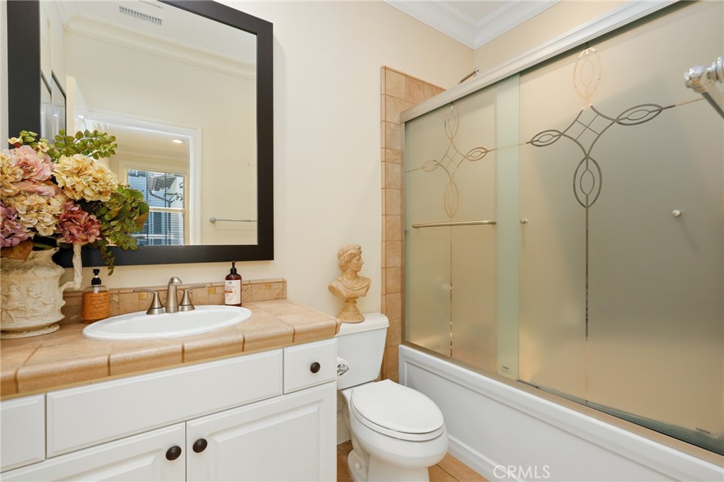 1 David Street Ladera Ranch, CA 92694 - Photo 28 of 66 a bathroom with a granite countertop sink toilet mirror and shower