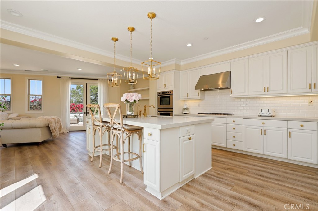 1 David Street Ladera Ranch, CA 92694 - Photo 9 of 66 a open kitchen with white cabinets and wooden floor