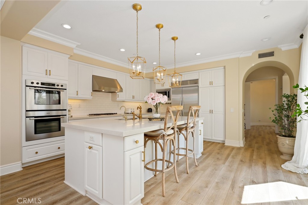1 David Street Ladera Ranch, CA 92694 - Photo 10 of 66 a kitchen with stainless steel appliances kitchen island granite countertop a stove a sink a refrigerator and a wooden cabinets