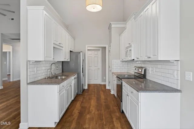 a kitchen with cabinets appliances and a counter space