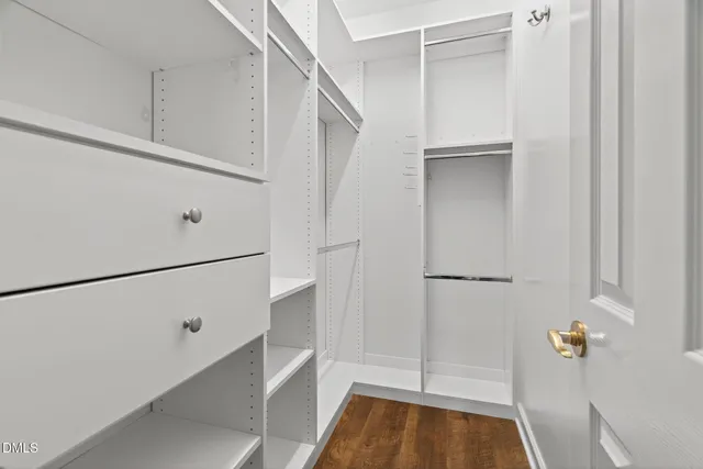 a bathroom with a granite countertop double vanity sink and a mirror