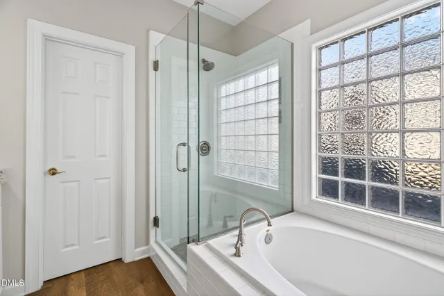 a white bath tub sitting next to a window