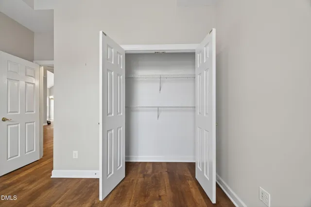 a bathroom with a granite countertop sink a toilet a mirror and shower