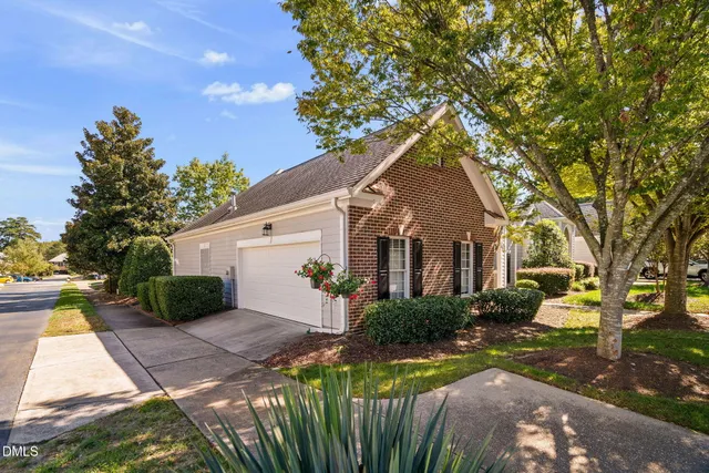 a view of a house with a tree next to a yard