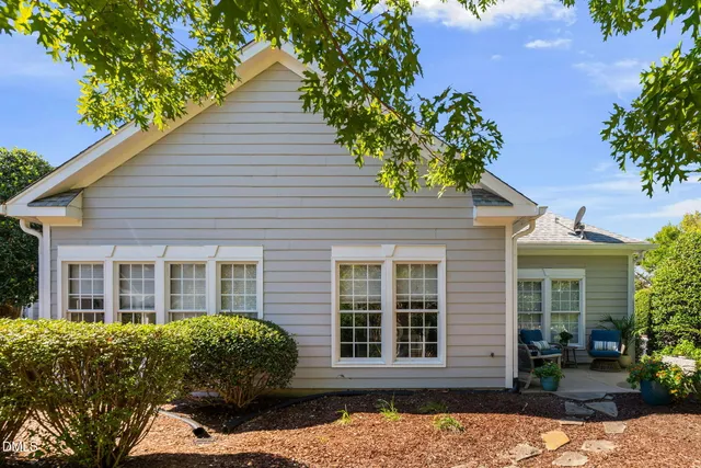 a view of a patio with chairs and potted plants