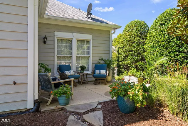 a view of a patio with table and chairs and potted plants