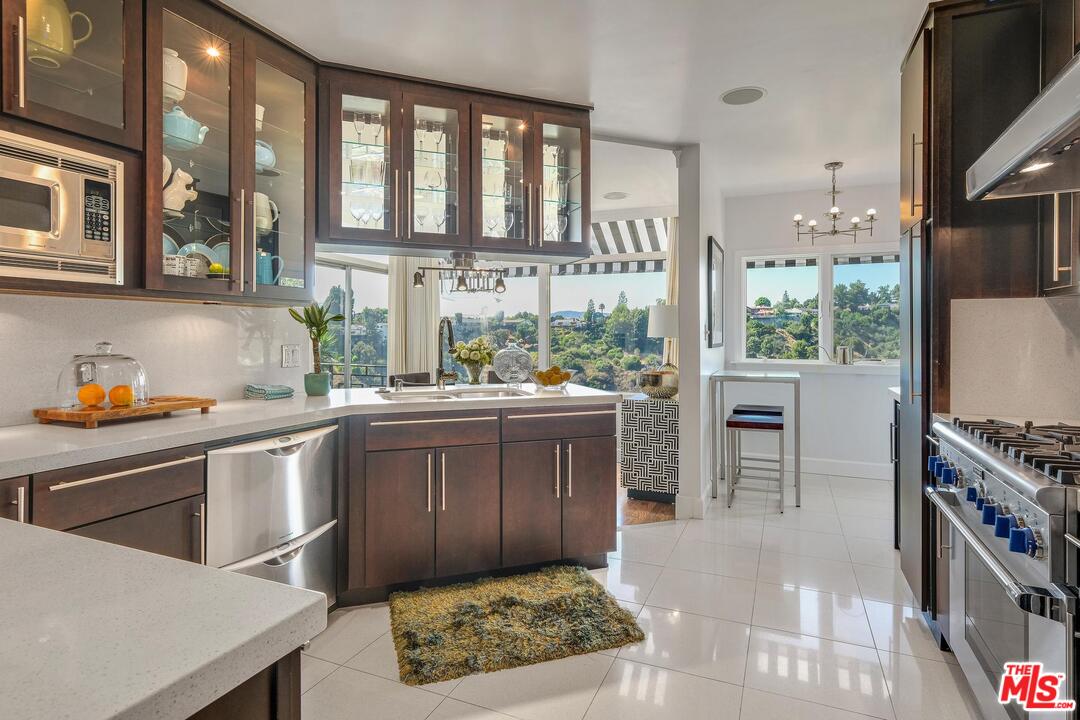 2019 Stradella Road Los Angeles, CA 90077 - Photo 15 of 45 a kitchen with stainless steel appliances granite countertop a stove a sink and a microwave