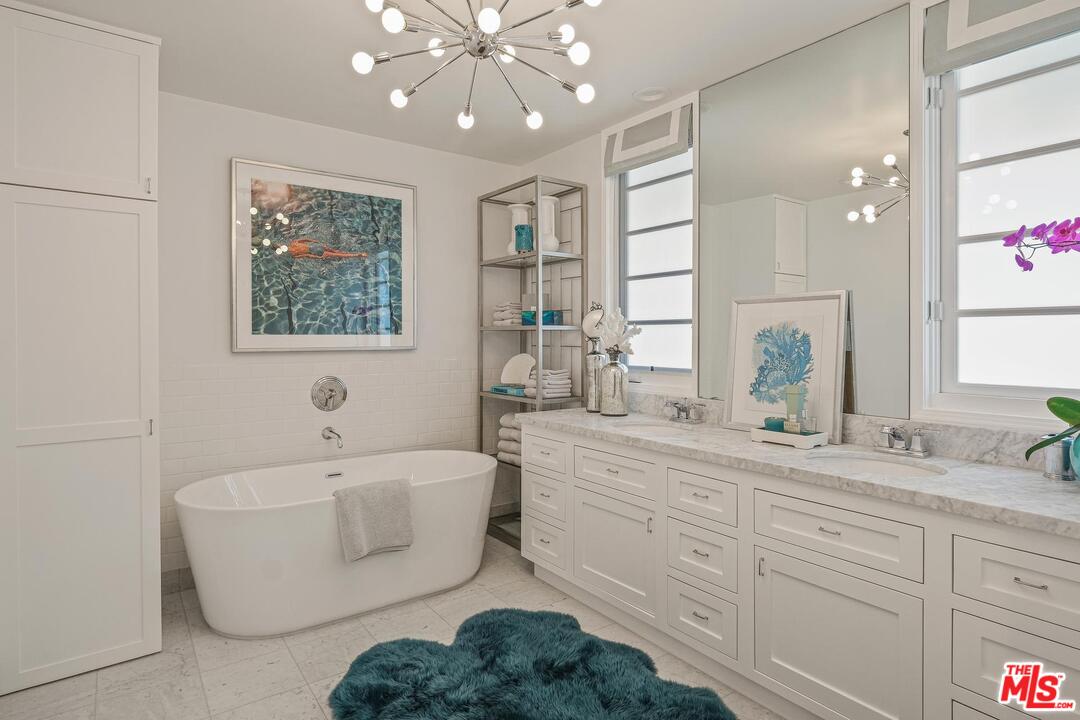 2019 Stradella Road Los Angeles, CA 90077 - Photo 19 of 45 a bathroom with a sink a large mirror and a bathtub