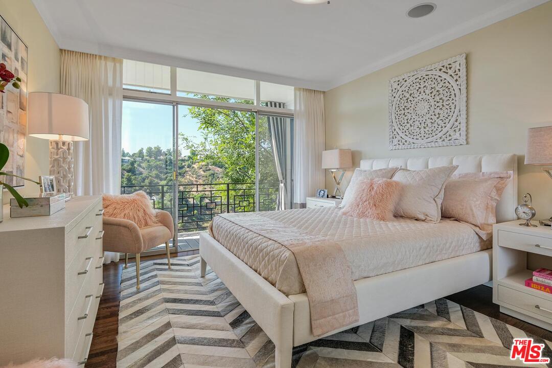 2019 Stradella Road Los Angeles, CA 90077 - Photo 24 of 45 a bedroom with a bed and a large window