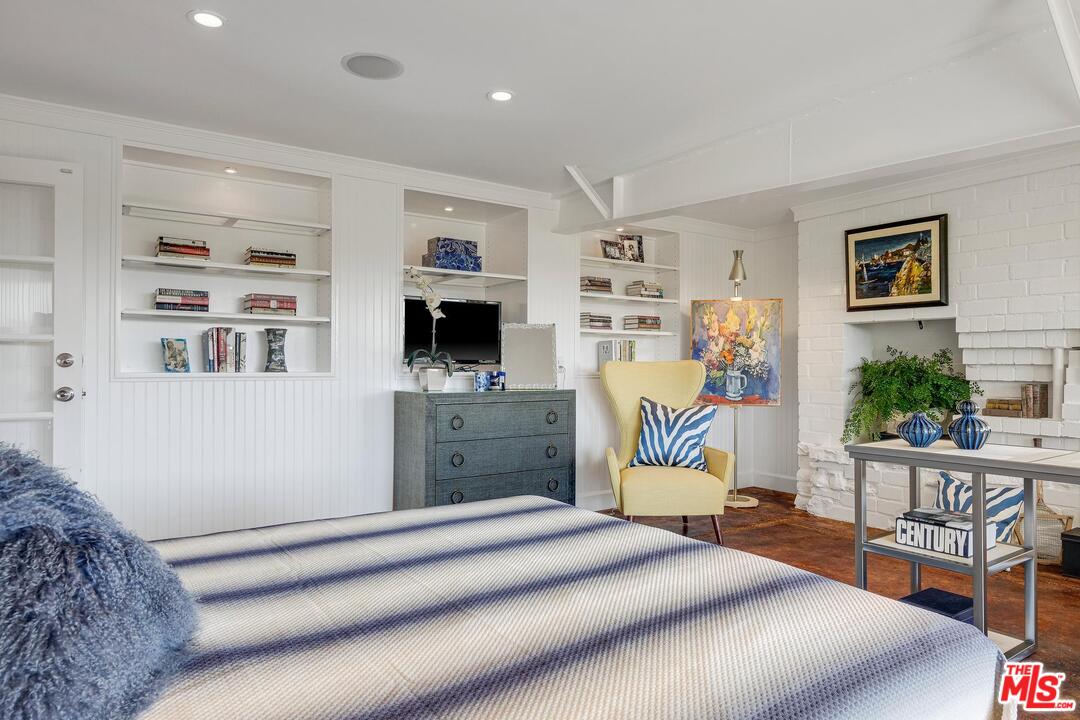 2019 Stradella Road Los Angeles, CA 90077 - Photo 27 of 45 a bedroom with furniture and a flat screen tv