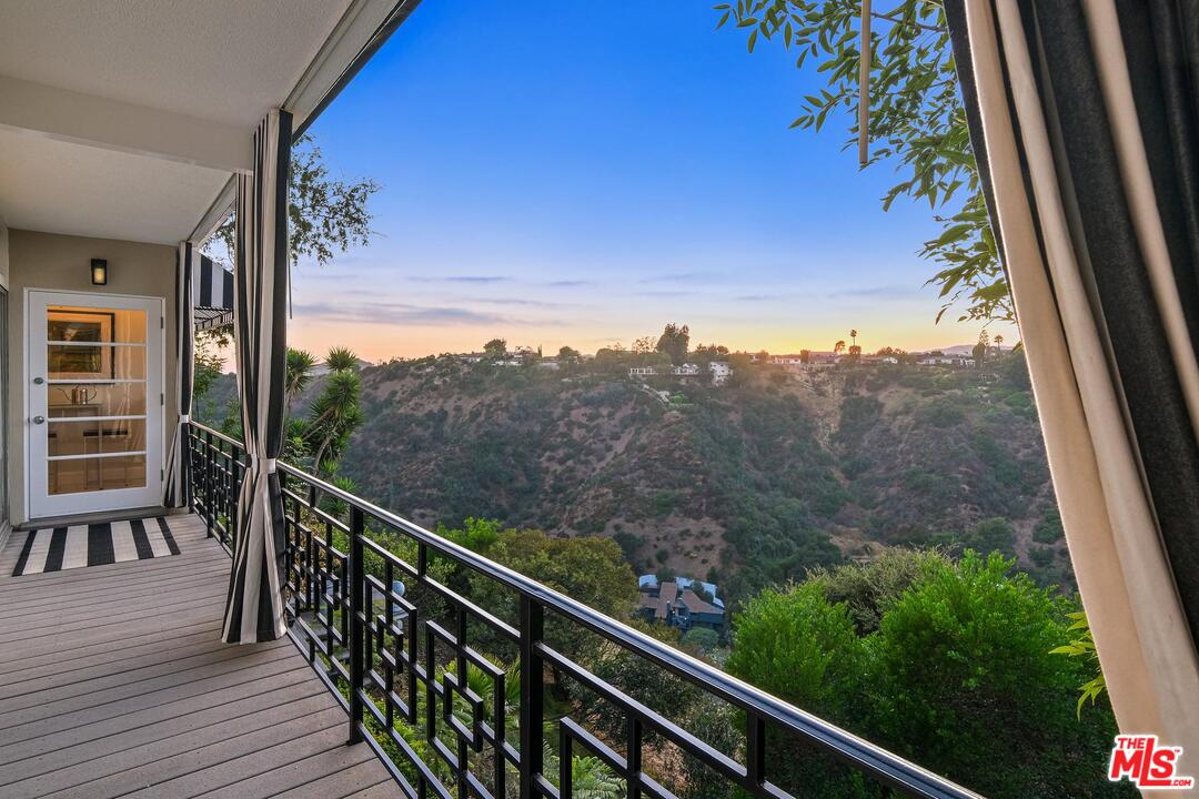 2019 Stradella Road Los Angeles, CA 90077 - Photo 34 of 45 a view of a balcony with wooden fence and floor