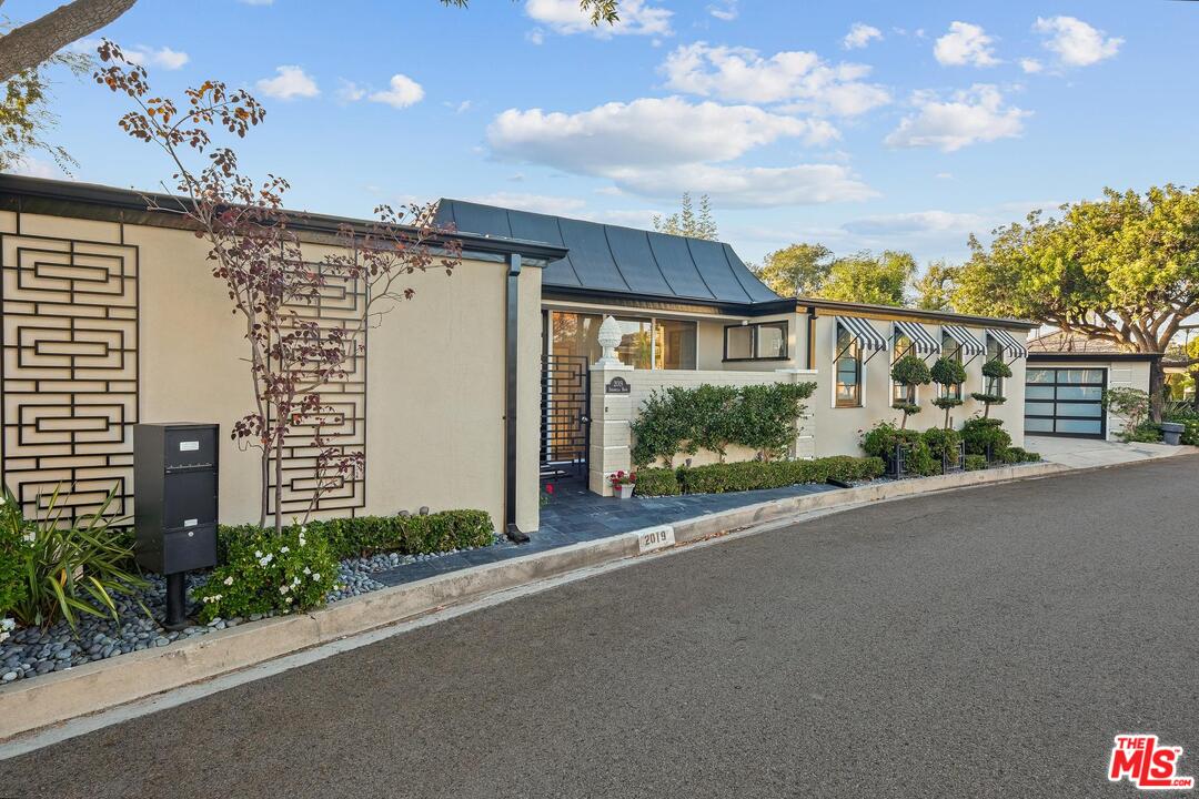 2019 Stradella Road Los Angeles, CA 90077 - Photo 42 of 45 a view of a house with a garden