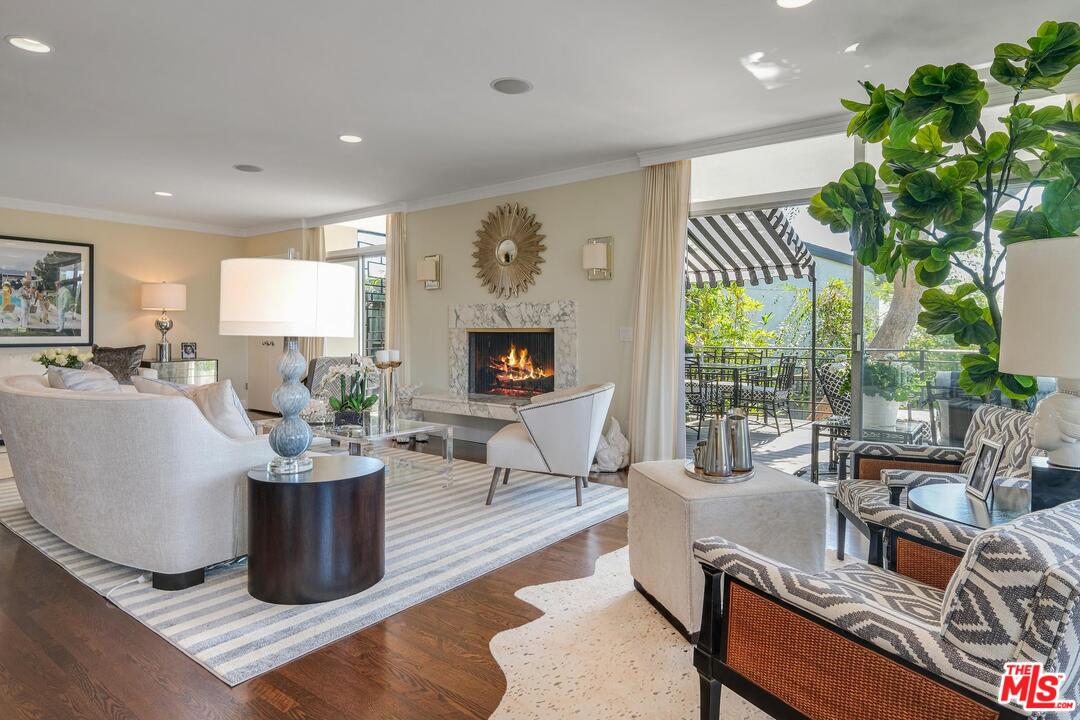 2019 Stradella Road Los Angeles, CA 90077 - Photo 7 of 45 a living room with fireplace furniture and a potted plant