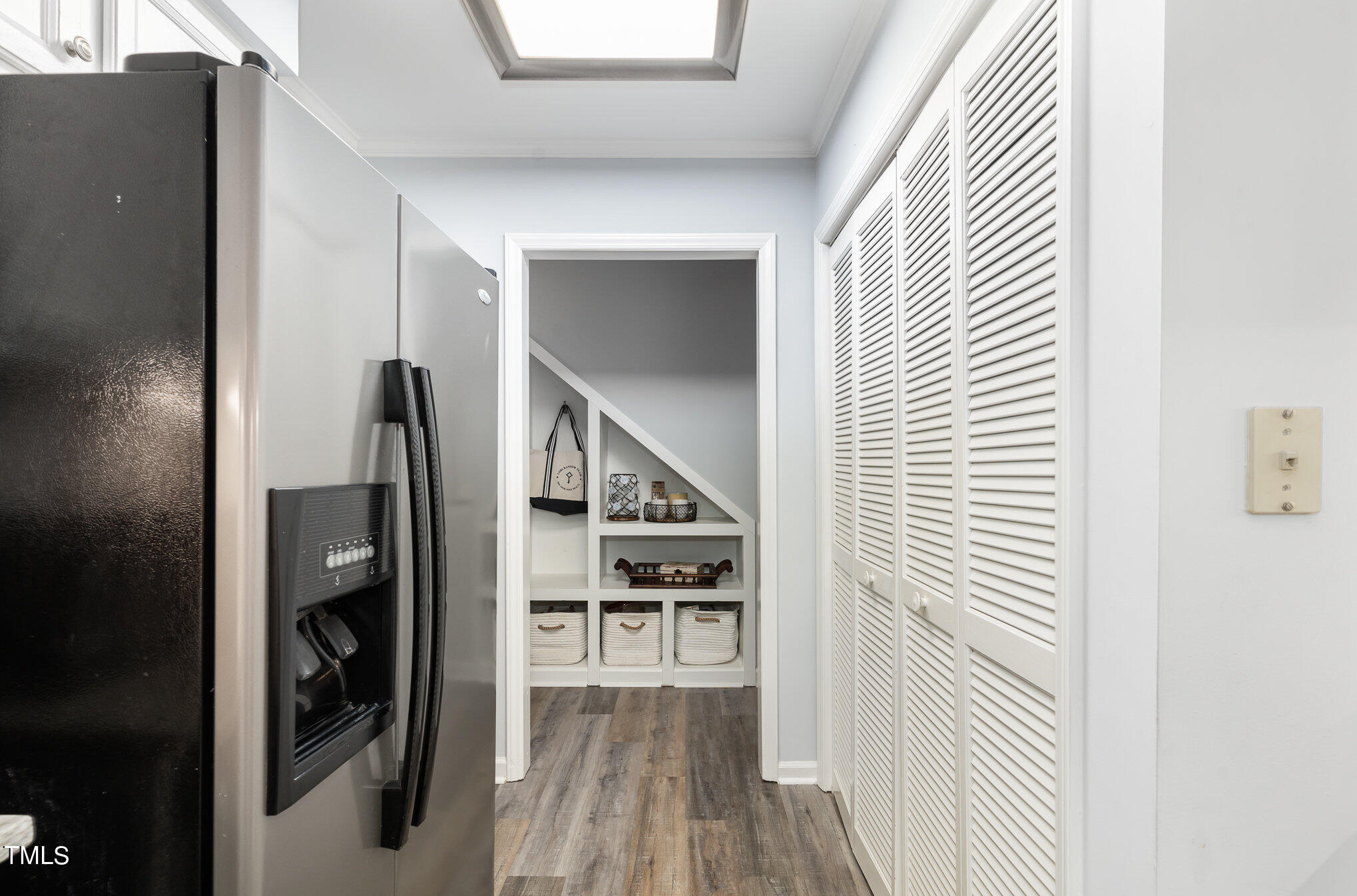 5515 Hamstead Crossing Raleigh, NC 27612 - Photo 7 of 17 a view of hallway with stairs and wooden floor