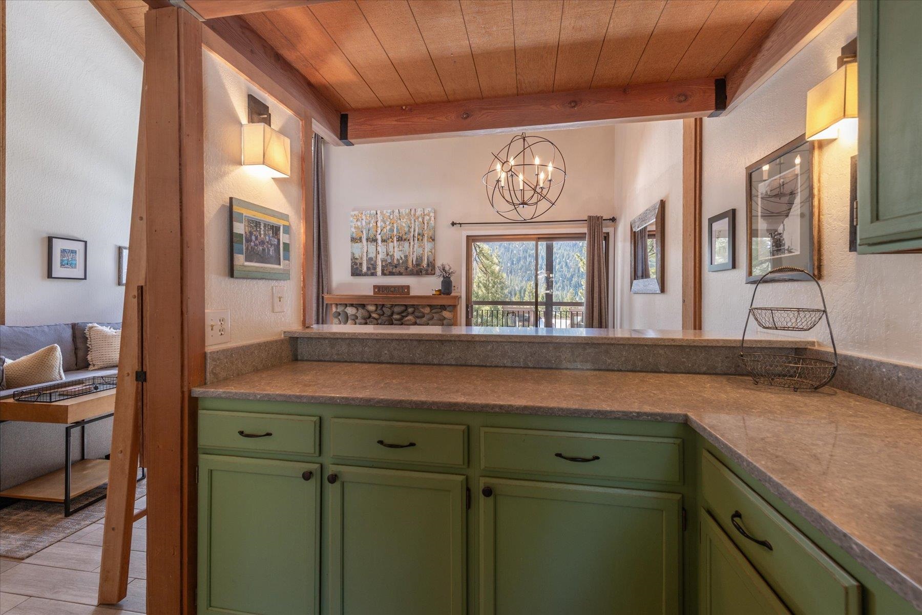6090 Rocky Point Truckee, CA 96161 - Photo 11 of 28 a kitchen with a wooden floor and a large window