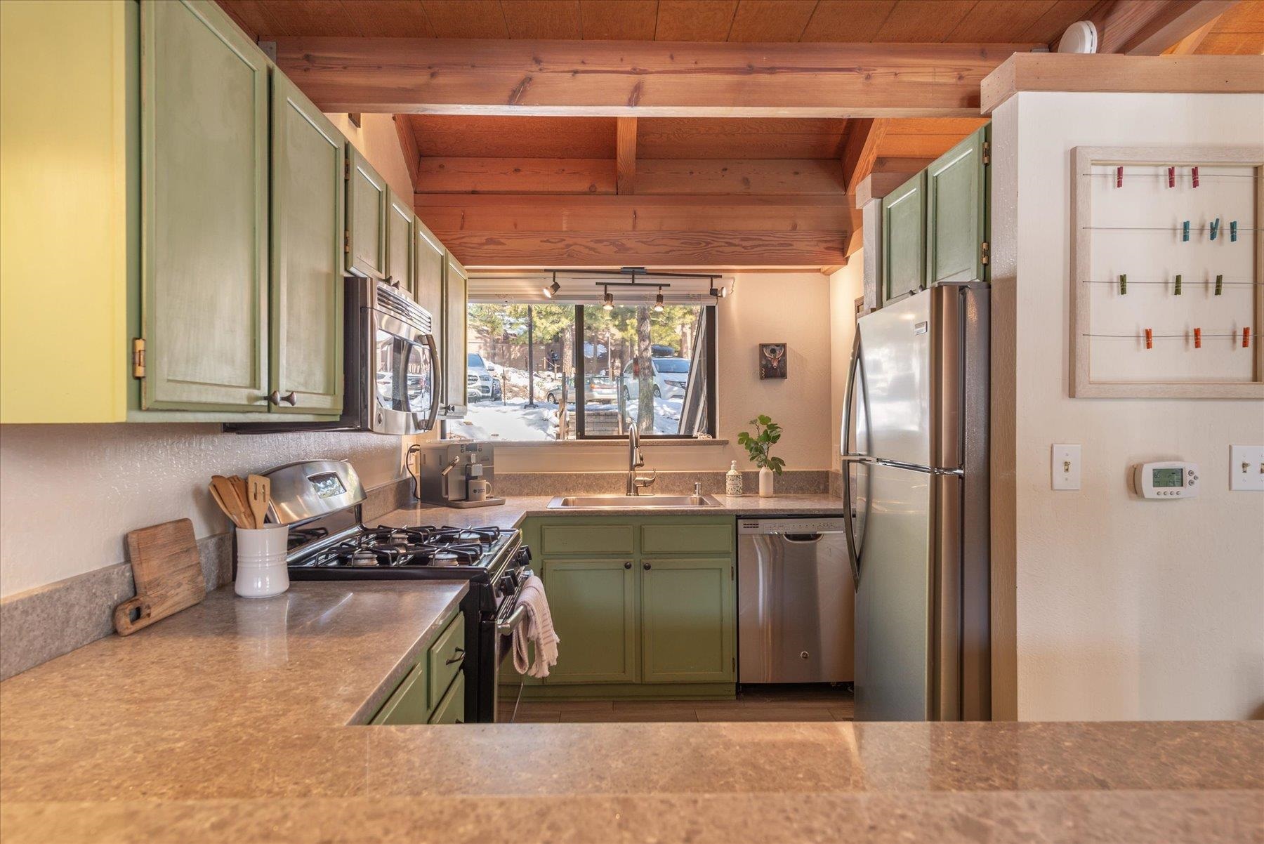 6090 Rocky Point Truckee, CA 96161 - Photo 9 of 28 a kitchen with a sink refrigerator and cabinets