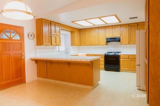 905 Harriet Street Ridgecrest, CA 93555 - Photo 12 of 34 a kitchen with stainless steel appliances granite countertop a sink and a refrigerator