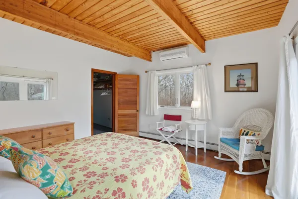 a bedroom with a bed a table and chair