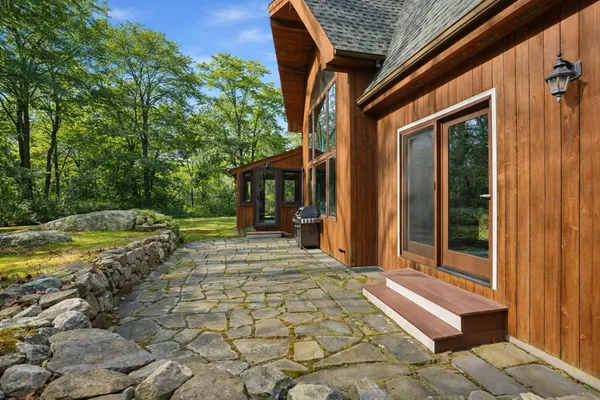 a view of a house with backyard and porch