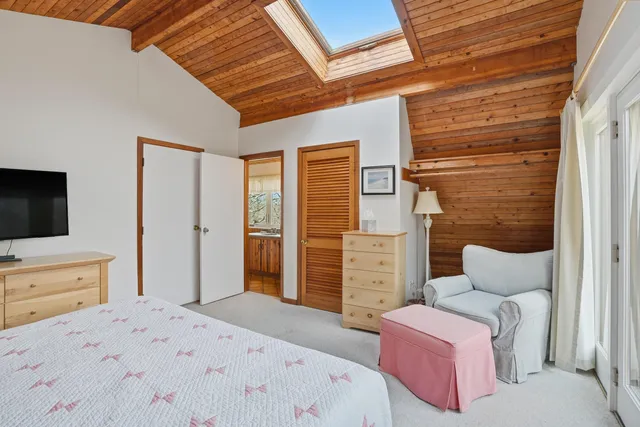 a bedroom with a bed and a television