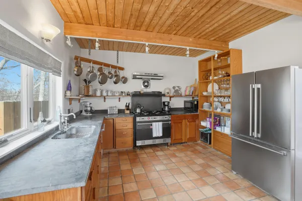 a kitchen with stainless steel appliances granite countertop a refrigerator and a stove