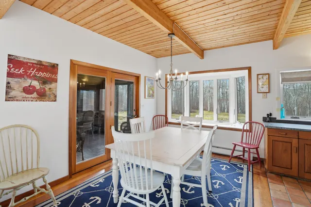 a dining room with furniture a chandelier and wooden floor