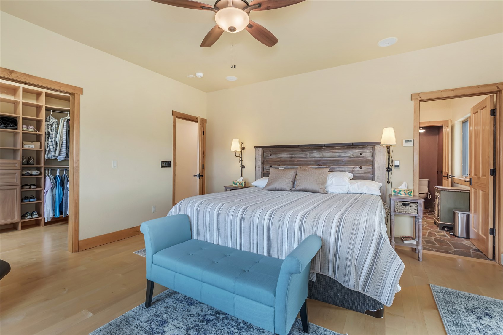 31485 Deerwood Ranch Road Steamboat Springs, CO 80487 - Photo 33 of 49 a bedroom with a large bed and a chandelier