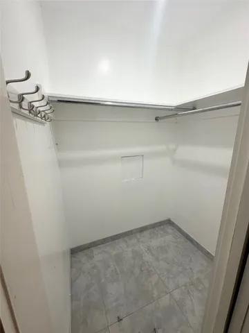 a view of a room with shelf on the wall