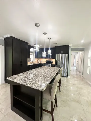 a kitchen with a table and chairs