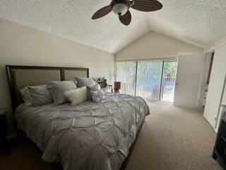 6170 Vía Tierra Boca Raton, FL 33433 - Photo 11 of 13 a large bed sitting in a bedroom next to a window