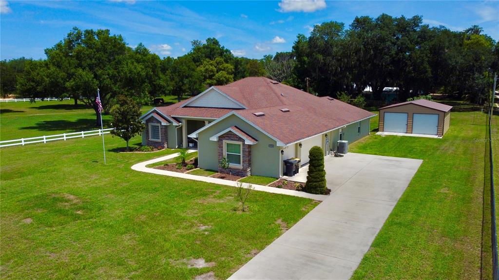 3934 Connersville Road Bartow, FL 33830 - Photo 80 of 81 a view of a house with a big yard potted plants and large tree